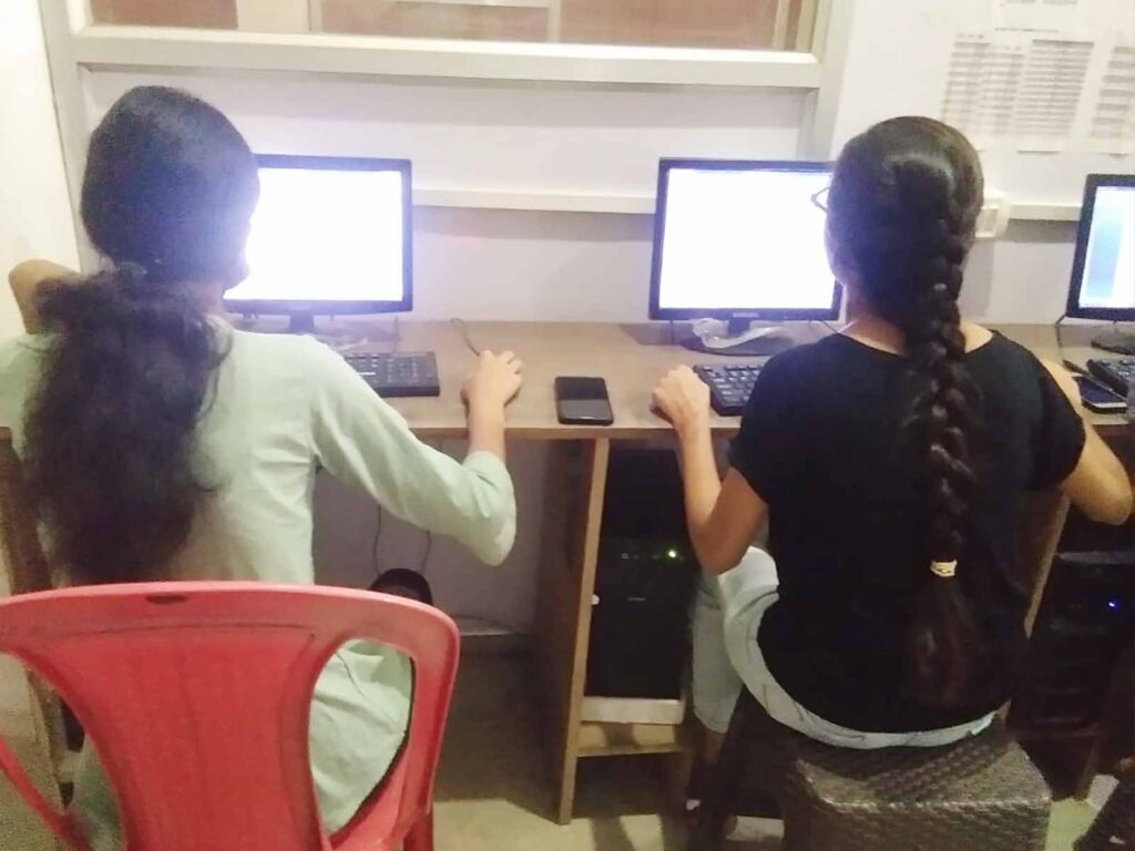 2 Girls learning Computer