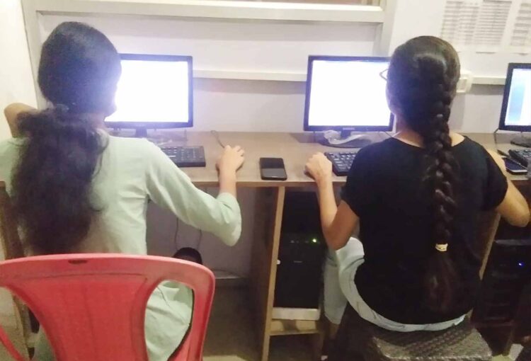 2 Girls learning Computer